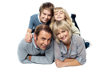 Image showing Adorable young kids piled on top of their parents