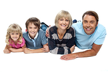 Image showing Smiling family of four relaxing on white background