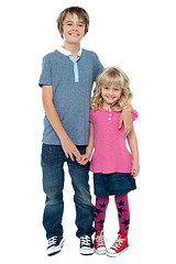 Image showing Smart boy holding cute sisters hand and embracing her