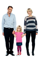 Image showing Cute daughter holding hands of her parents tightly