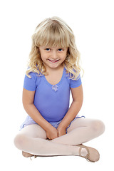 Image showing Adorable kid sitting with crossed legs on the floor