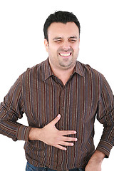 Image showing Young man suffering from a bad stomach ache pain isolated on whi