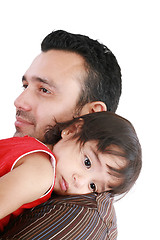 Image showing beautiful little girl hugging embracing her father.  Focus in th