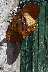 Image showing Stylish straw hat on the wall