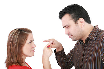 Image showing Young couple pointing at each other against a white background 