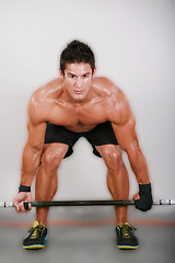 Image showing Young man lifting the barbell in the gym. 