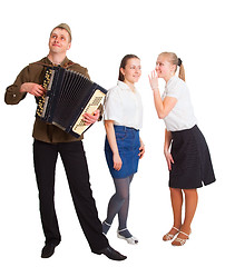 Image showing A guy with an accordion and two girls
