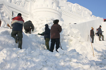 Image showing making figures of snow in winter park.