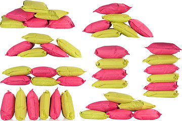 Image showing bright pink and green pillows isolated on white