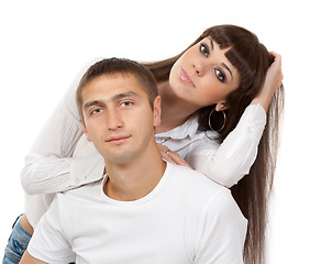 Image showing portrait of a beautiful young couple in the studio on a white ba