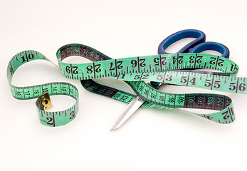 Image showing Green measuring tape and scissors 