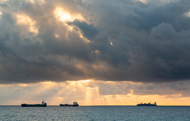 Image showing Three cargo freight ships on horizon