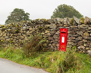 Image showing Old King George red post box in stone wall