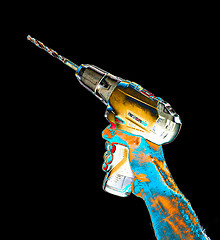 Image showing Senior mans arm holding a power drill