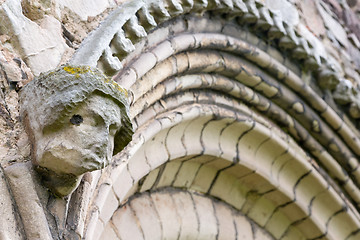 Image showing Ancient eroded head of saint on church