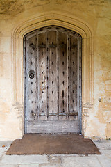Image showing Ancient oak wooden door in stone surround