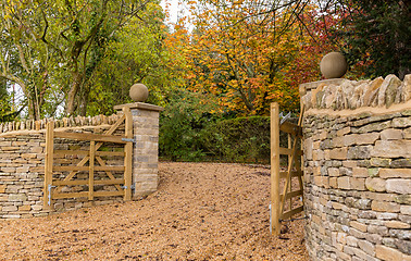 Image showing Open wooden gates at entrance to modern house