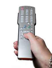 Image showing Close up of TV remote control with hand