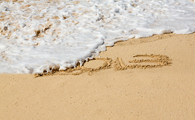 Image showing 2013 written in sand with waves