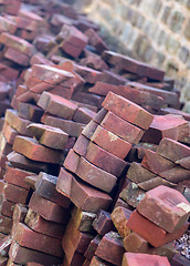 Image showing Stack of unusual shaped hand made bricks