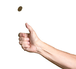 Image showing Man's arm and hand tossing golden coin
