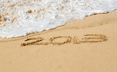 Image showing 2013 written in sand with waves