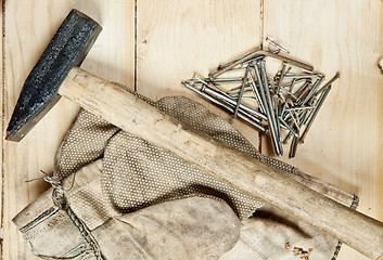 Image showing Vintage hammer with nails on wood background