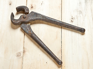 Image showing nippers on wood background