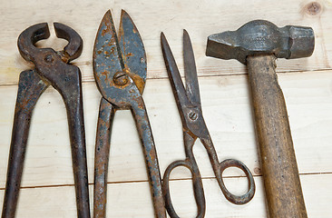 Image showing Hammer and nippers on wood background