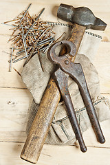 Image showing Vintage hammer with nails on wood background