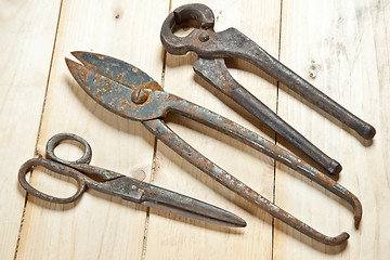 Image showing nippers on wood background