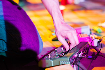 Image showing Musician adjusting effects