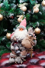 Image showing Santa Claus with gifts under a Christmas fir-tree