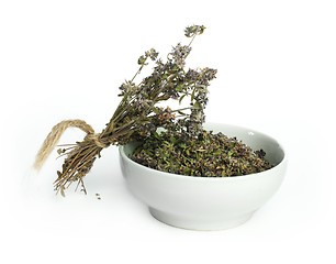 Image showing Dried thyme in a bowl and thyme twigs