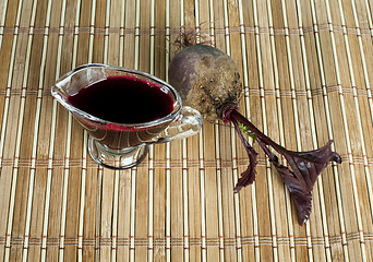 Image showing Red beets with leaves and jug with juice