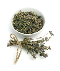 Image showing Dried thyme in a bowl and thyme twigs