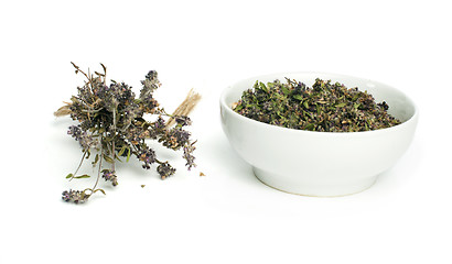 Image showing Dried thyme in a bowl and thyme twigs