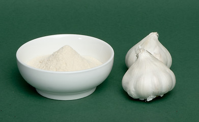 Image showing Crushed garlic powder and whole garlic