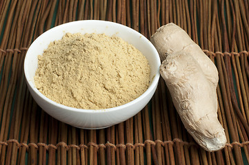 Image showing Powdered ginger in a bowl and whole ginger