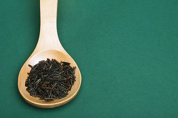 Image showing Wild black rice in wooden spoon