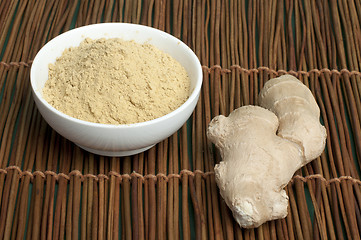 Image showing Powdered ginger in a bowl and whole ginger