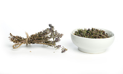 Image showing Dried thyme in a bowl and thyme twigs