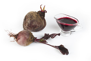 Image showing Red beets with leaves and jug with juice