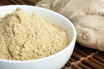 Image showing Powdered ginger in a bowl and whole ginger