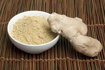 Image showing Powdered ginger in a bowl and whole ginger