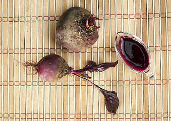 Image showing Red beets with leaves and jug with juice