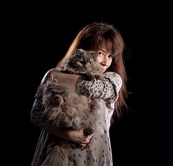 Image showing Young beautiful smiling woman holds fluffy cat