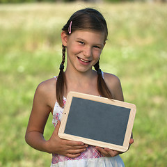 Image showing Girl holding a small blackboard