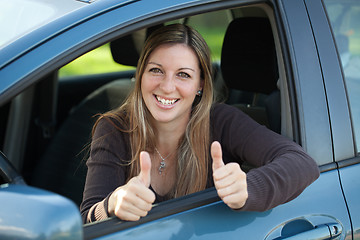 Image showing Happy female driver showing thumbs up