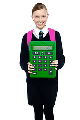 Image showing School girl holding large green calculator
